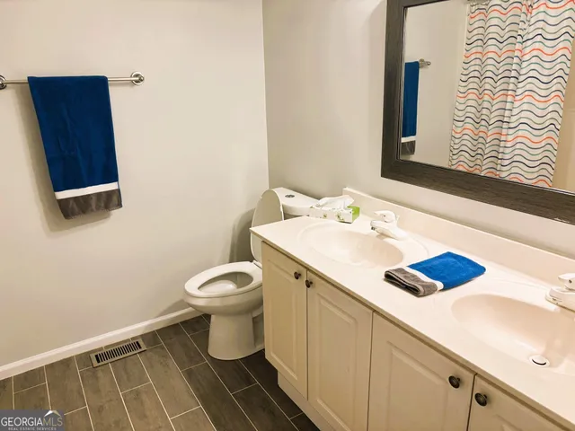 a bathroom with a tub shower and a sink