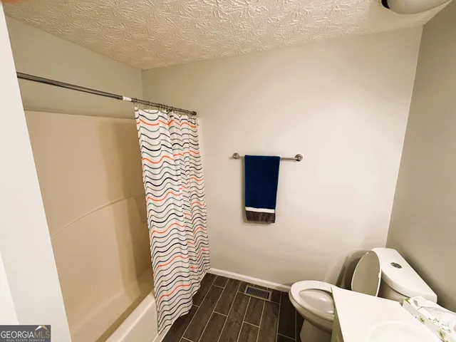 a bathroom with a toilet and a window