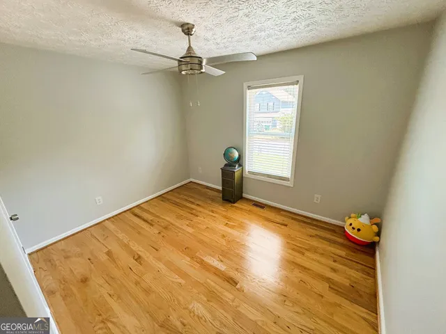 a view of a hallway with wooden floor and entryway