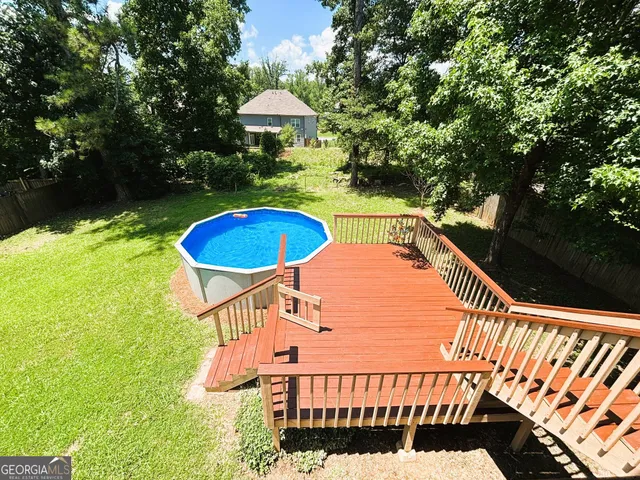 a view of a house with swimming pool and sitting area