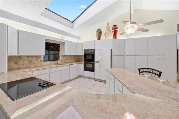 a kitchen with a sink appliances and cabinets
