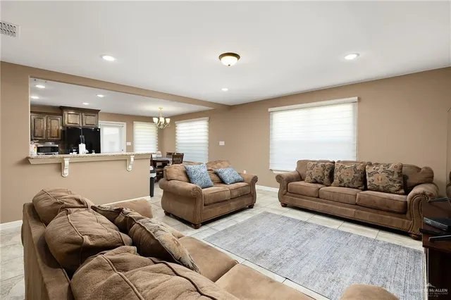 a living room with furniture and view of kitchen
