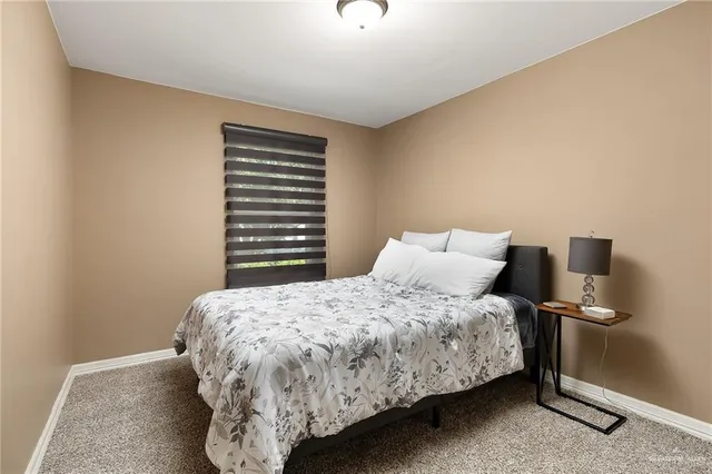 a bedroom with a bed and a night stand