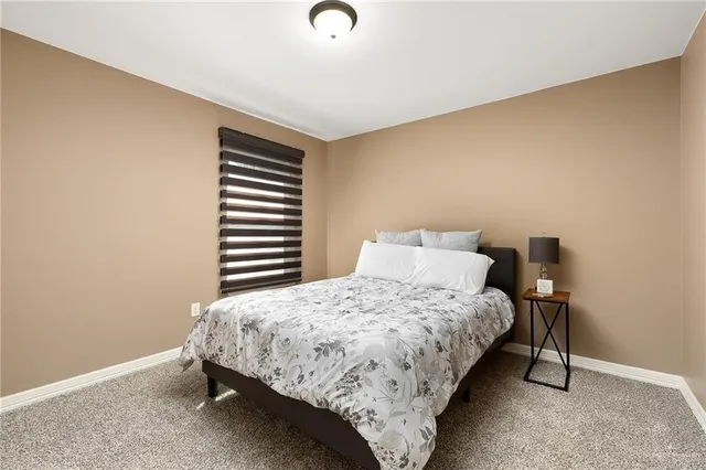 a bedroom with a bed and a chair