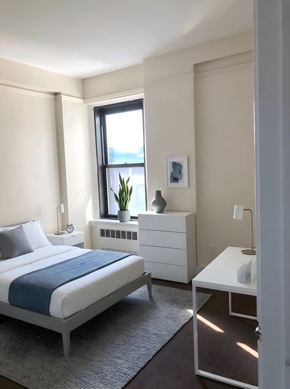 475 Commonwealth Avenue, Unit 605 Boston, MA 02215 - Photo 4 of 12 a bedroom with a bed and a window