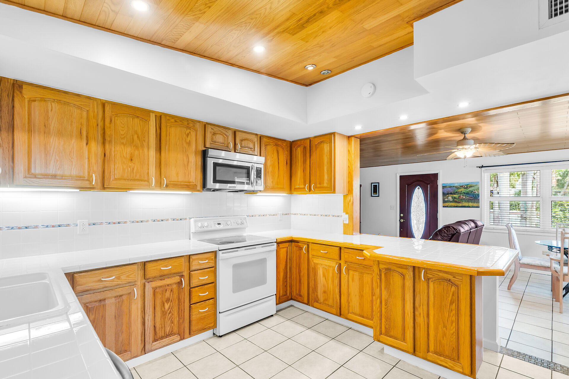 13 Bass Avenue Key Largo, FL 33037 - Photo 14 of 43 a kitchen with stainless steel appliances kitchen island granite countertop a sink and cabinets