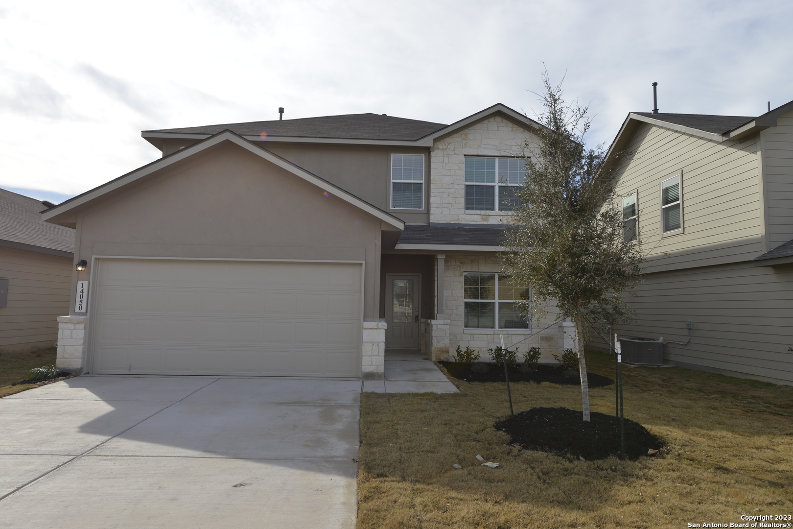 14050 Mudstone Street San Antonio, TX 78253 - Photo 1 of 30 a front view of a house with a yard and garage