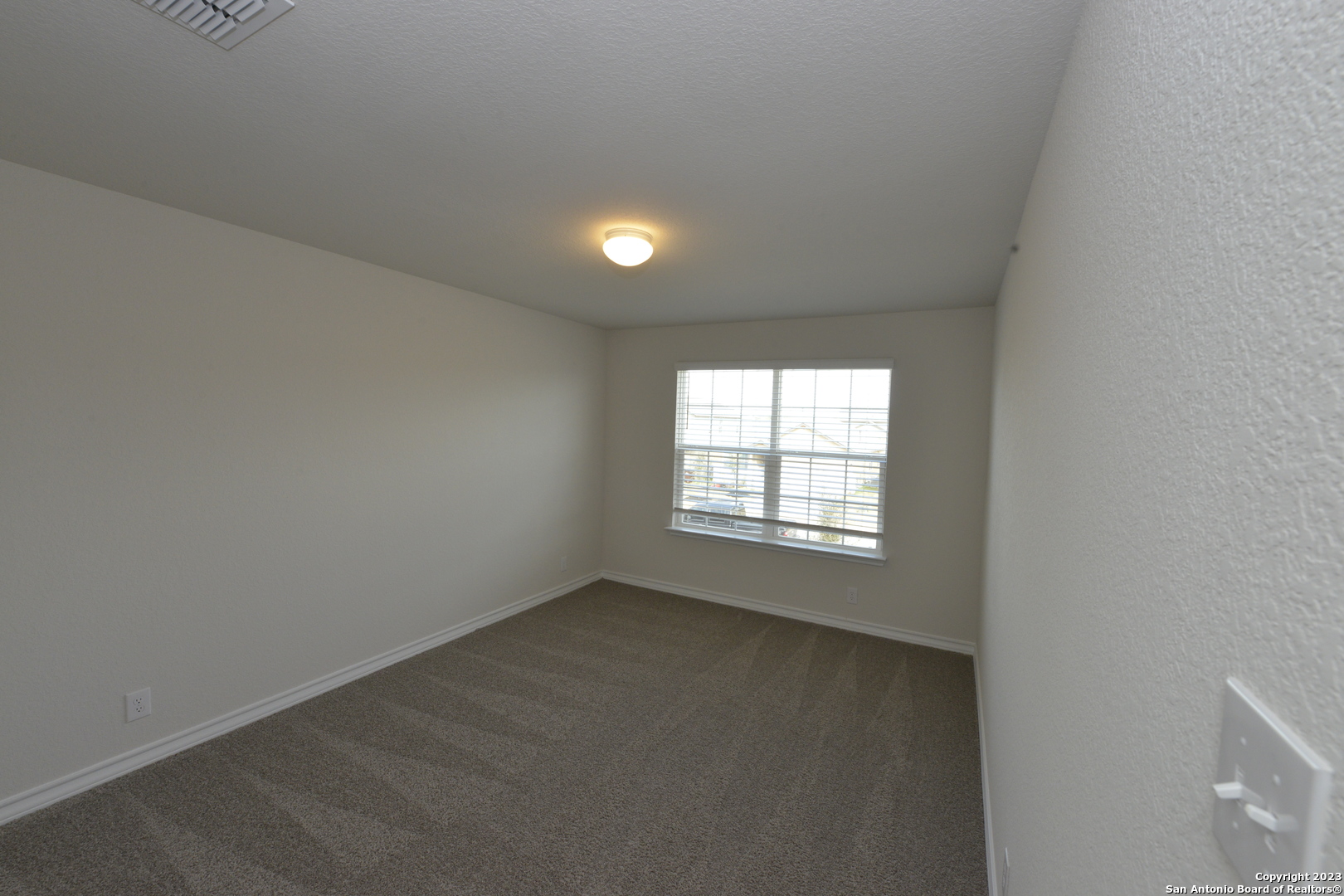 14050 Mudstone Street San Antonio, TX 78253 - Photo 14 of 30 an empty room with a window