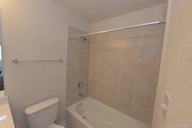 a white bath tub sitting next to a toilet