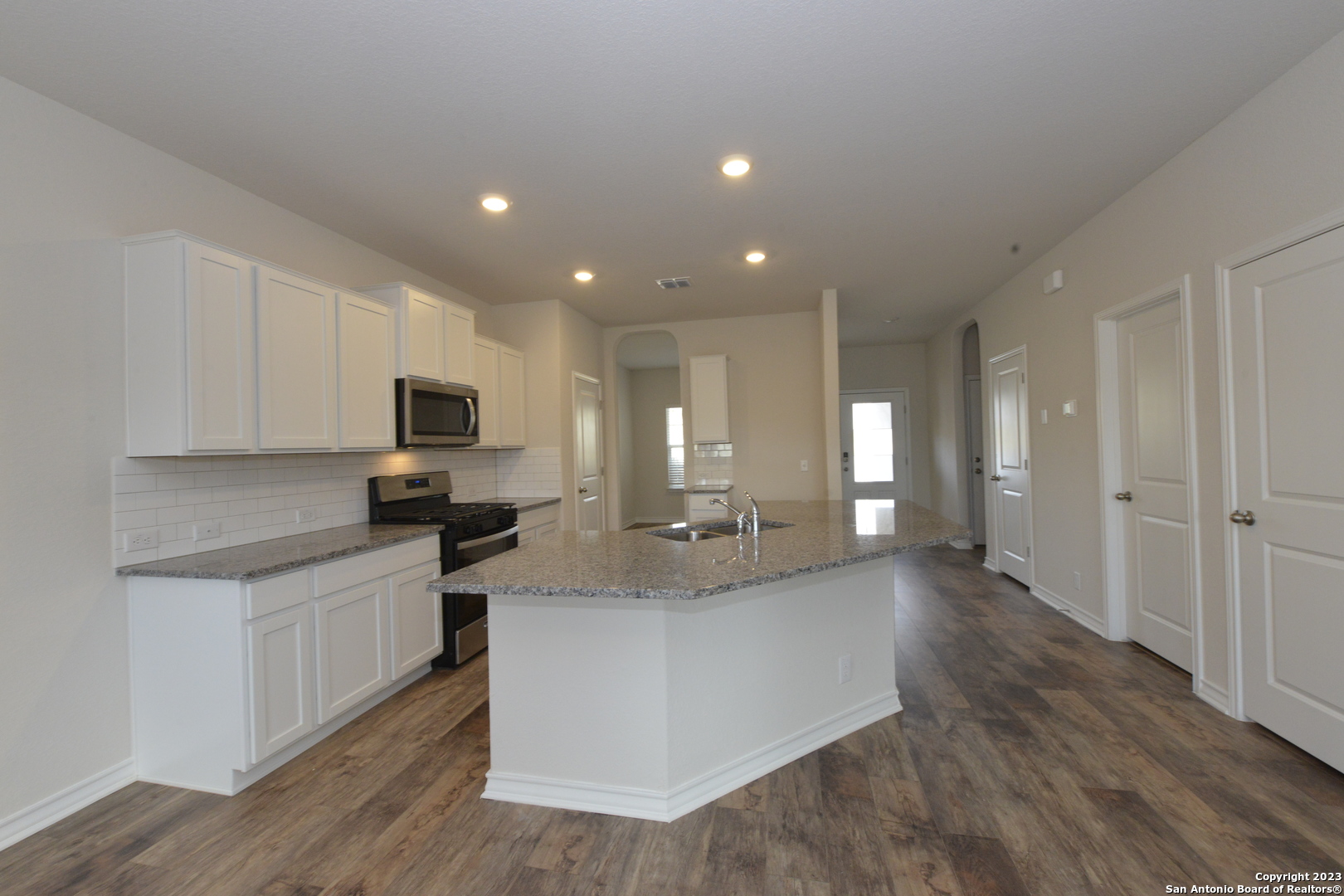 14050 Mudstone Street San Antonio, TX 78253 - Photo 2 of 30 a large kitchen with kitchen island a sink stainless steel appliances and cabinets
