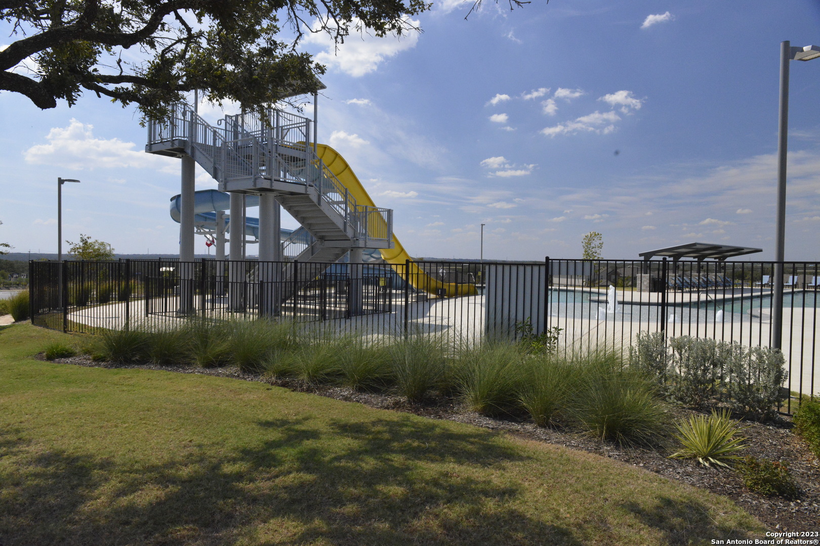 14050 Mudstone Street San Antonio, TX 78253 - Photo 27 of 30 a backyard of a house with lots of green space and lake view