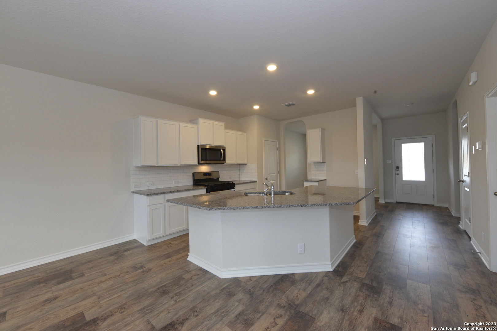 14050 Mudstone Street San Antonio, TX 78253 - Photo 5 of 30 a kitchen with stainless steel appliances a sink a stove a refrigerator and cabinets