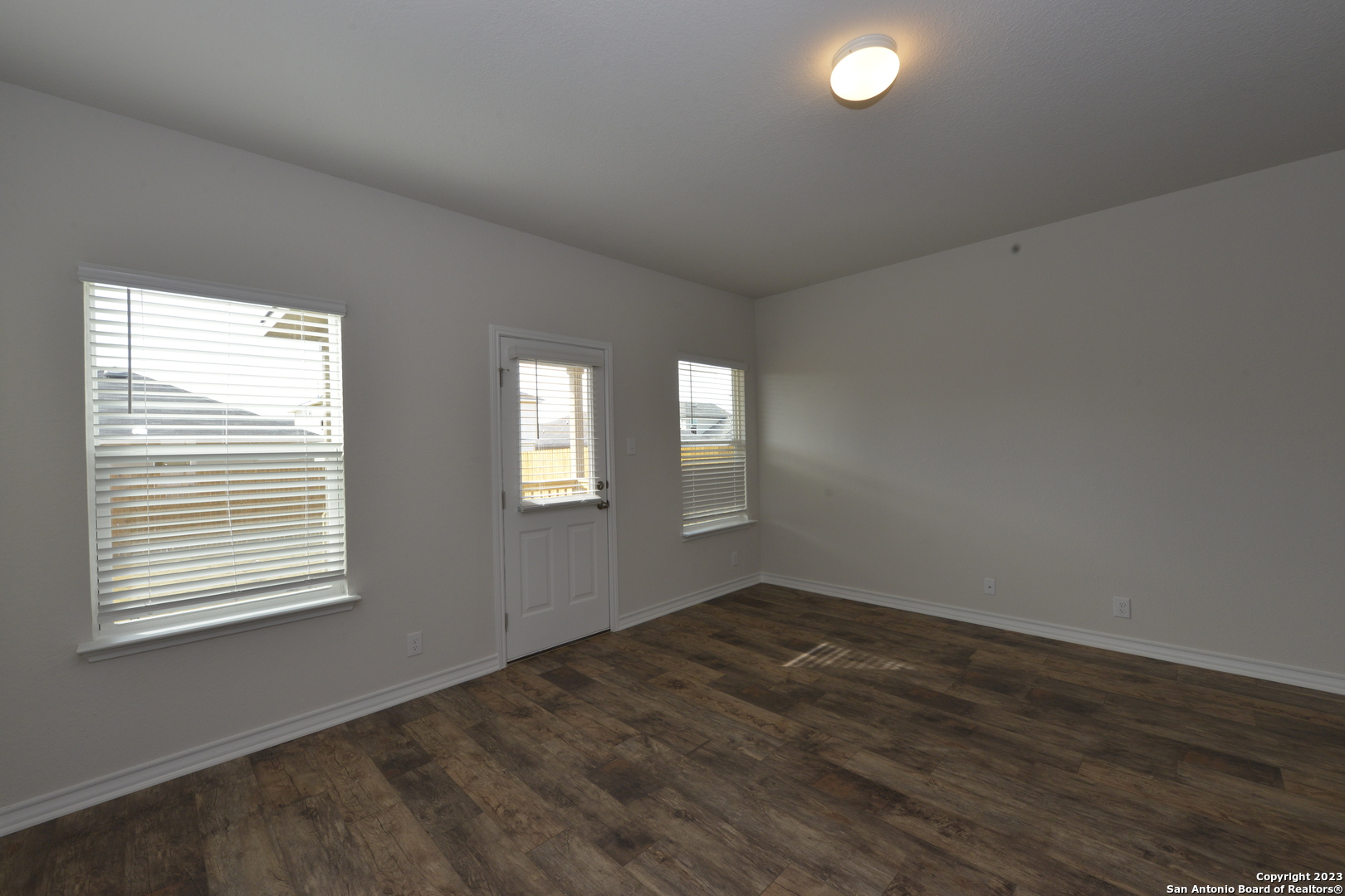 14050 Mudstone Street San Antonio, TX 78253 - Photo 6 of 30 a view of an empty room with wooden floor and a window