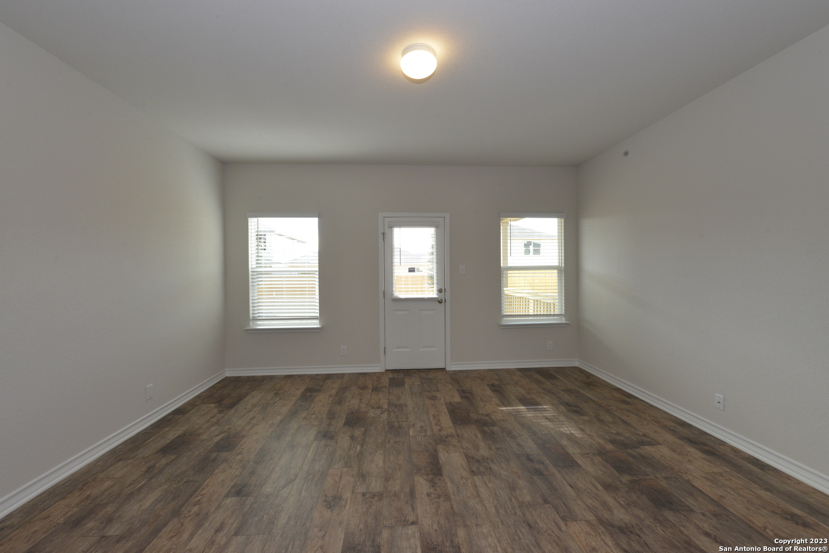 14050 Mudstone Street San Antonio, TX 78253 - Photo 7 of 30 a view of an empty room with wooden floor and a window