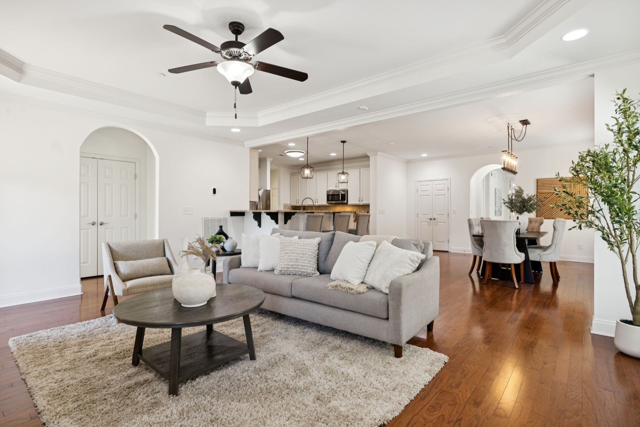 a living room with furniture or kitchen view and a chandelier