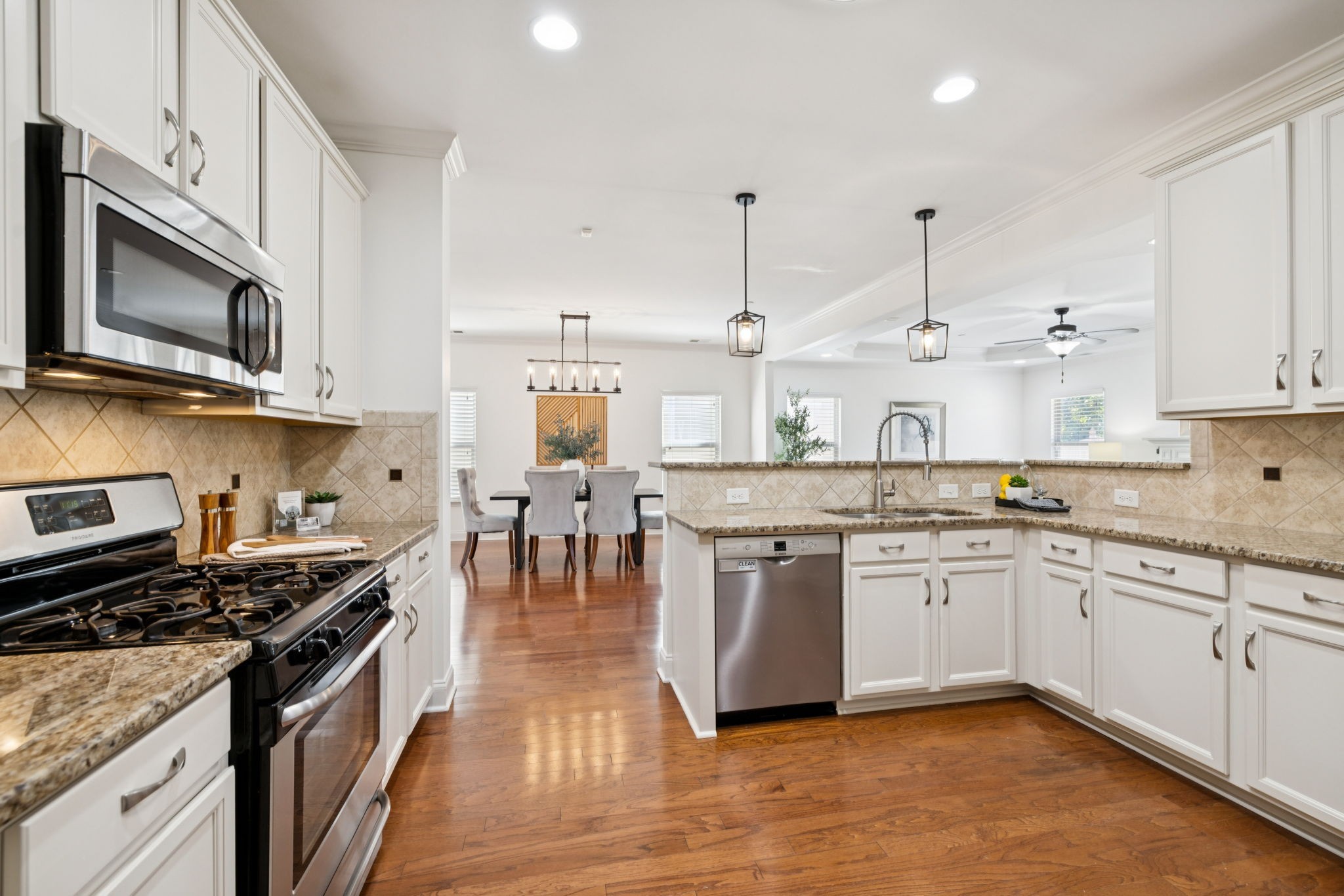 1009 Swanson Lane Franklin, TN 37064 - Photo 23 of 84 a kitchen with stainless steel appliances granite countertop a stove top oven a sink and a microwave