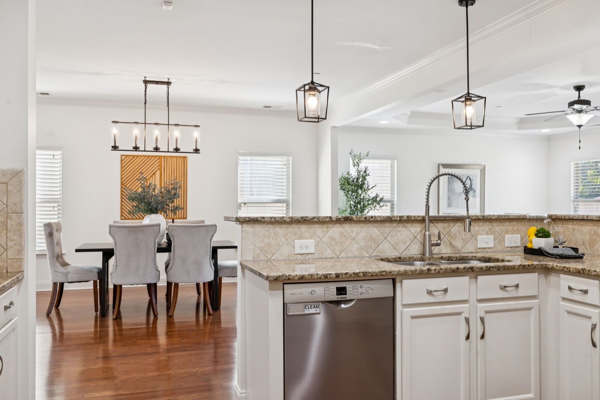 1009 Swanson Lane Franklin, TN 37064 - Photo 24 of 84 a kitchen with a kitchen island white cabinetry and wooden floor