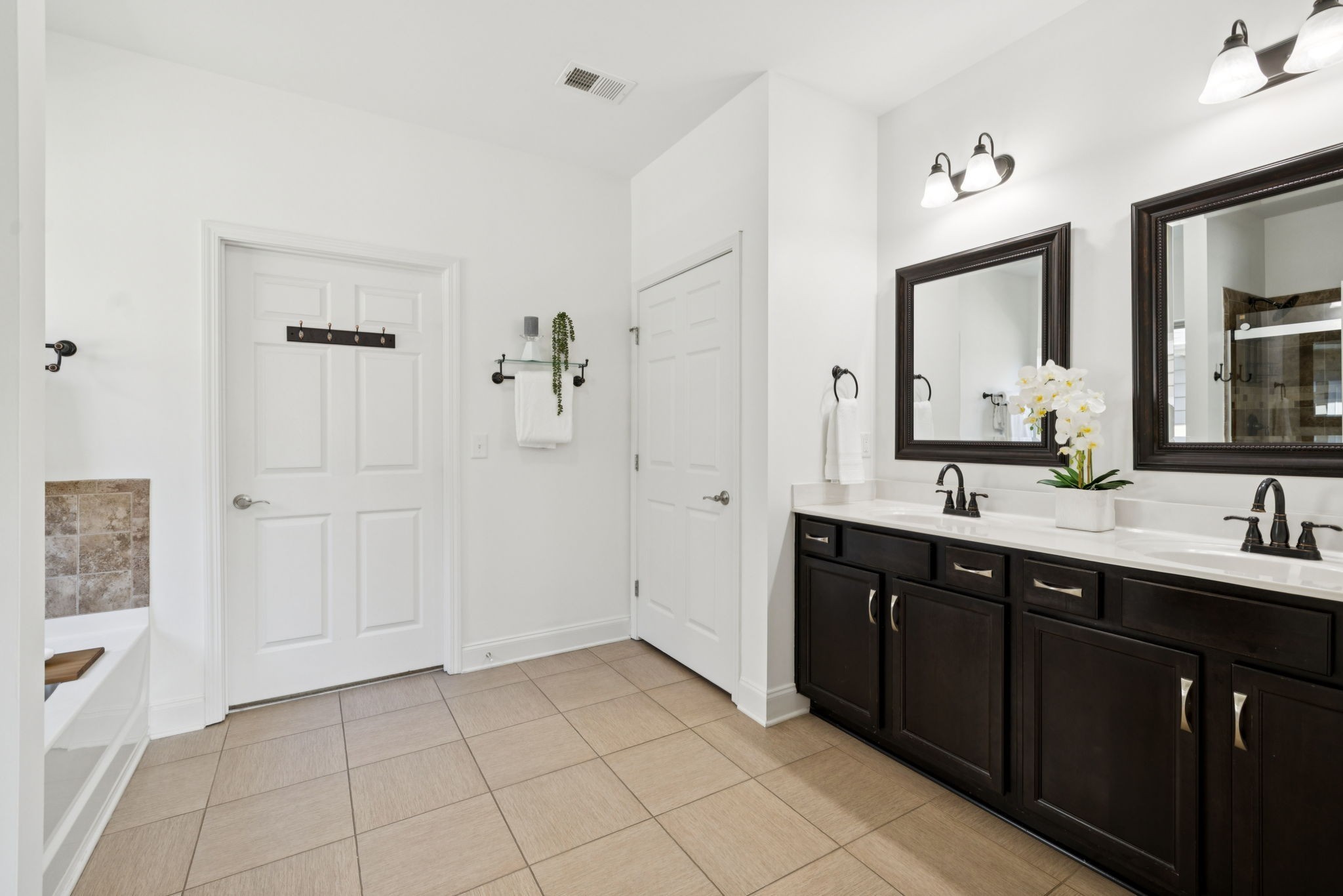 1009 Swanson Lane Franklin, TN 37064 - Photo 46 of 84 a spacious bathroom with a double vanity sink a mirror and a
