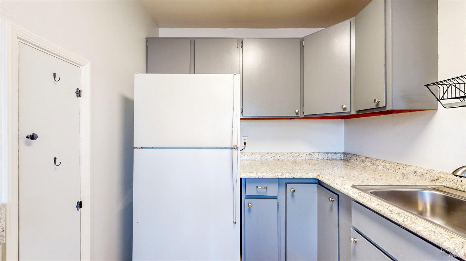 809 Maple Avenue Vallejo, CA 94591 - Photo 17 of 46 a white refrigerator freezer sitting inside of a kitchen