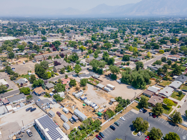 72 Cox Lane Midvale, UT 84047 - Photo 10 of 16 Aerial perspective showcasing a mixed-use neighborhood with residential properties and commercial structures