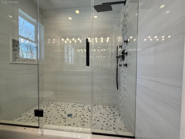 a bathroom with a glass shower door