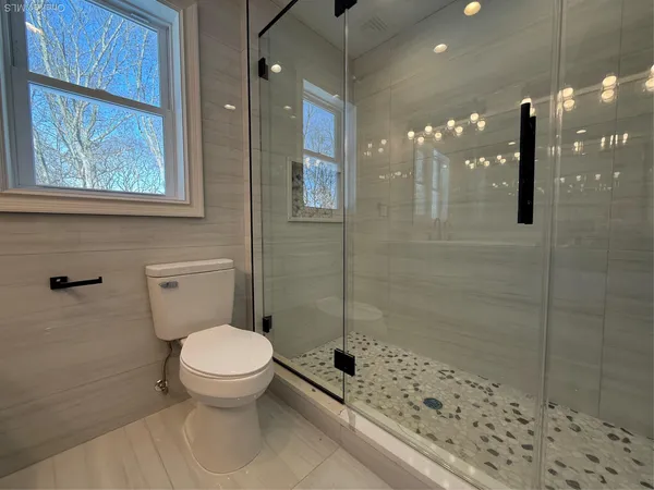 a bathroom with a toilet and shower