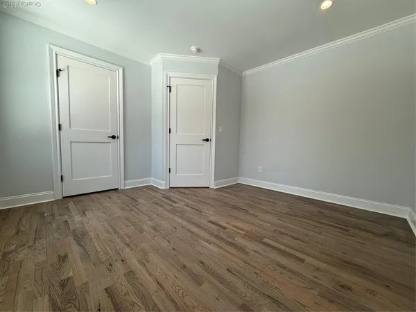 a view of an empty room and wooden floor