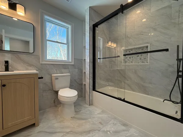 a bathroom with a toilet sink and a shower