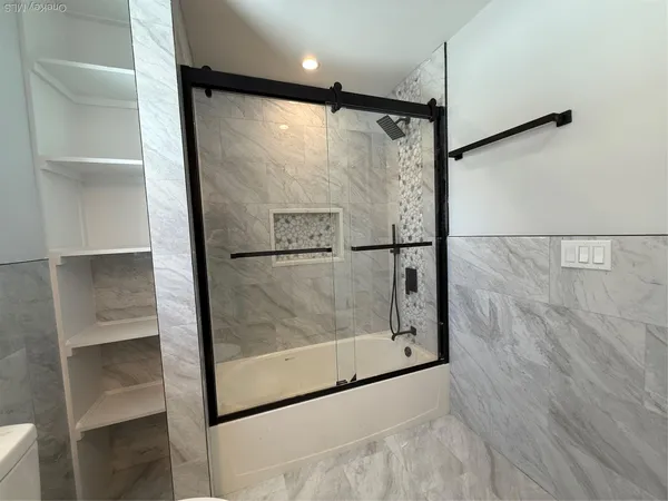 a bathroom with a glass shower door