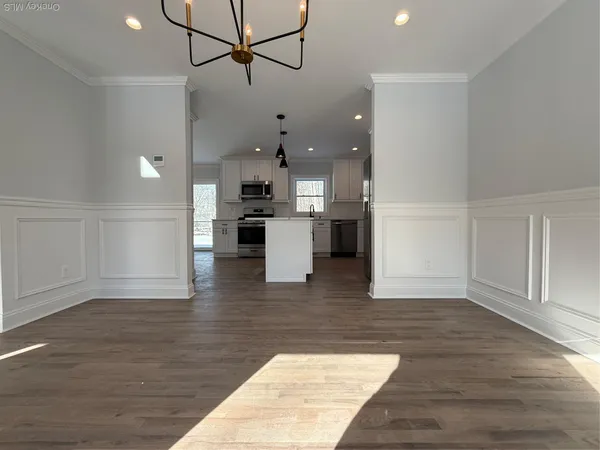 a open kitchen with white cabinets and stainless steel appliances