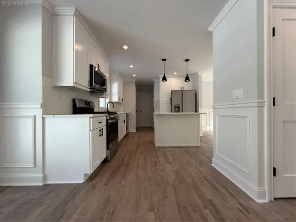 a kitchen with stainless steel appliances a refrigerator sink and cabinets
