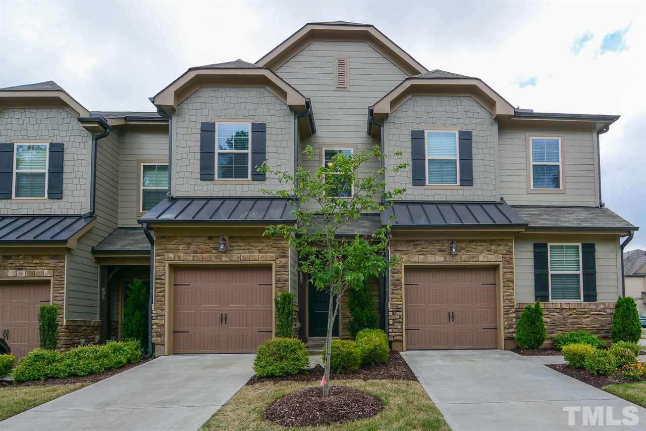 697 Wickham Ridge Road Apex, NC 27539 - Photo 1 of 25 a front view of a house with garage