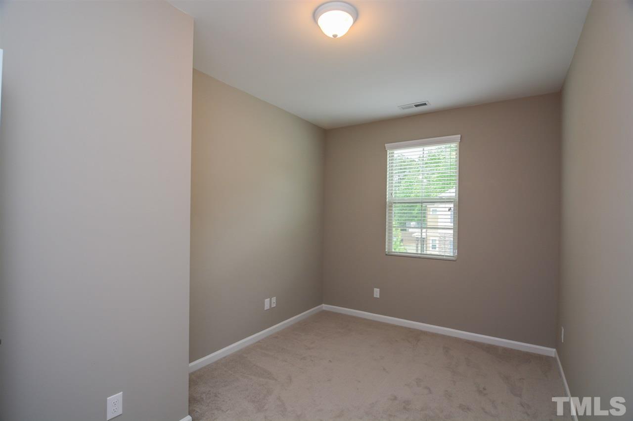 697 Wickham Ridge Road Apex, NC 27539 - Photo 18 of 25 an empty room with windows