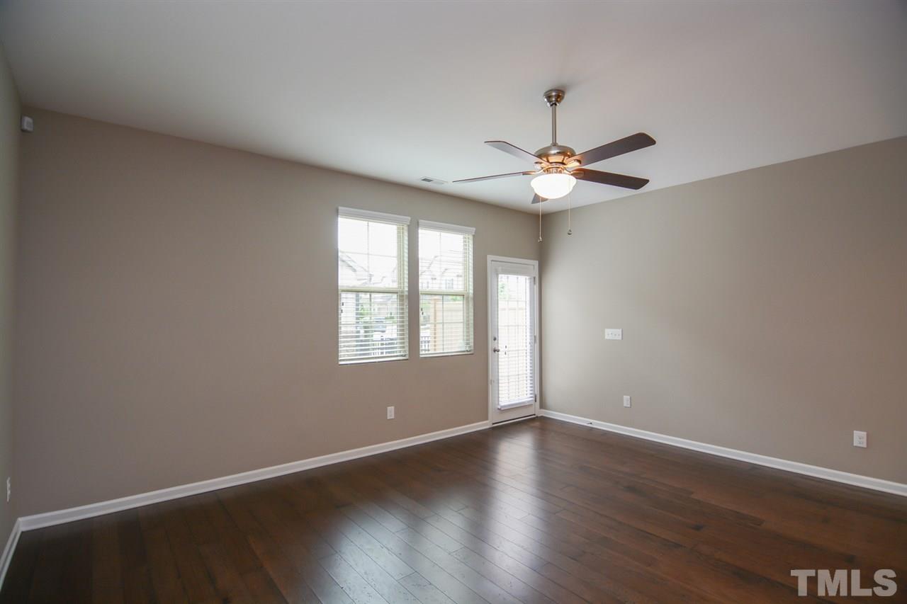 697 Wickham Ridge Road Apex, NC 27539 - Photo 10 of 25 an empty room with wooden floor and window
