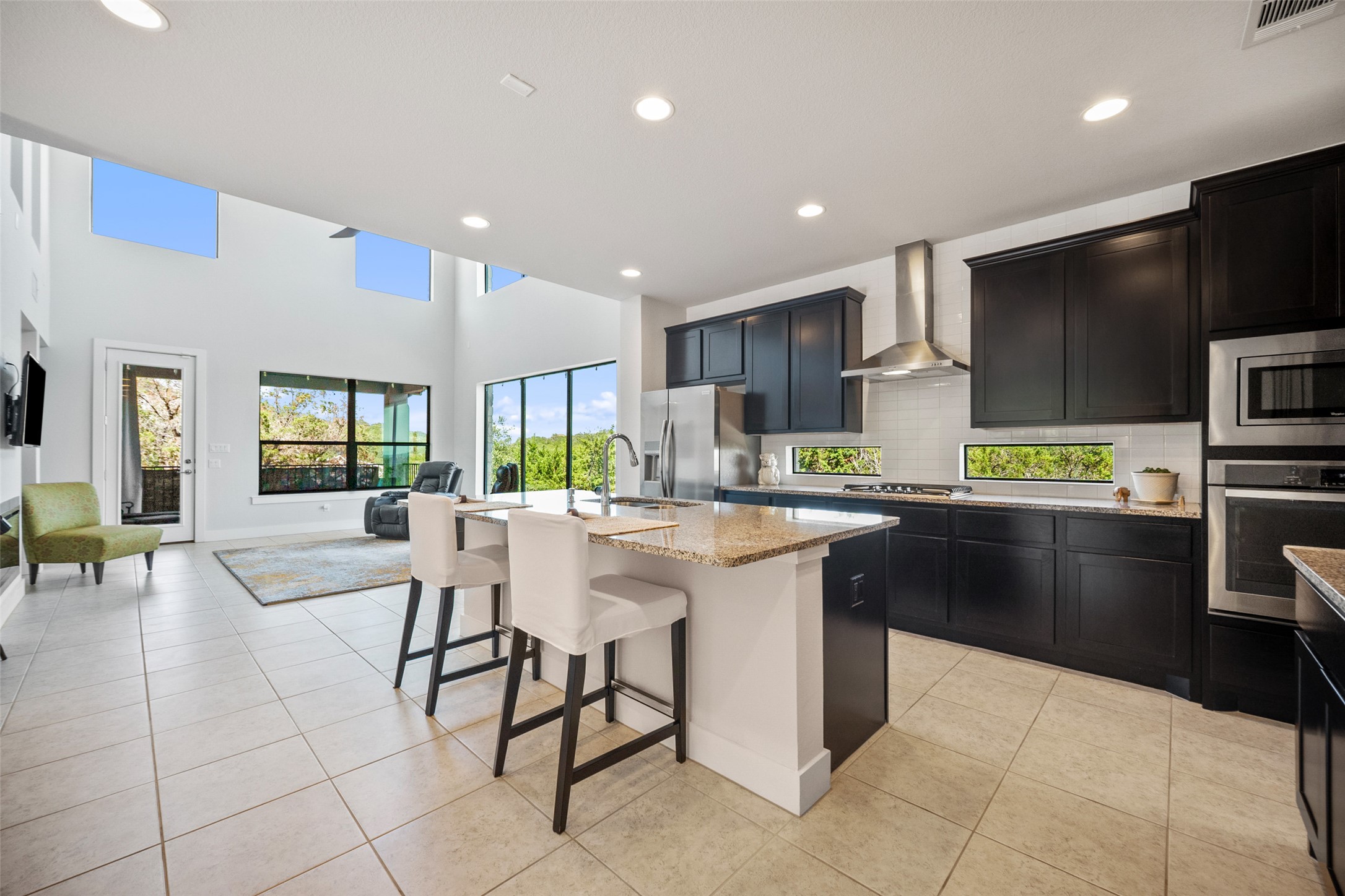 17644 West Reed Park Road Jonestown, TX 78645 - Photo 15 of 36 a kitchen with stainless steel appliances kitchen island granite countertop a sink and a stove top oven