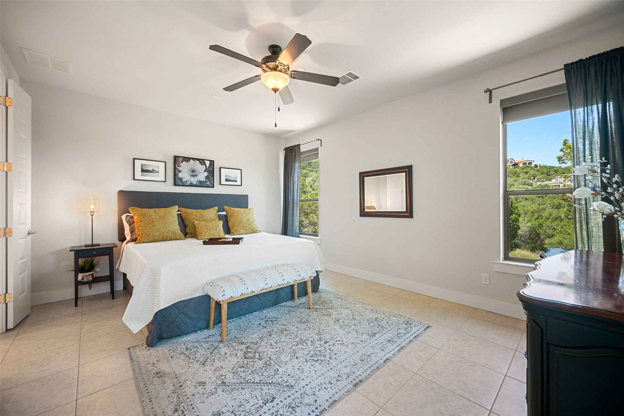 17644 West Reed Park Road Jonestown, TX 78645 - Photo 16 of 36 a bedroom with a bed and a chandelier