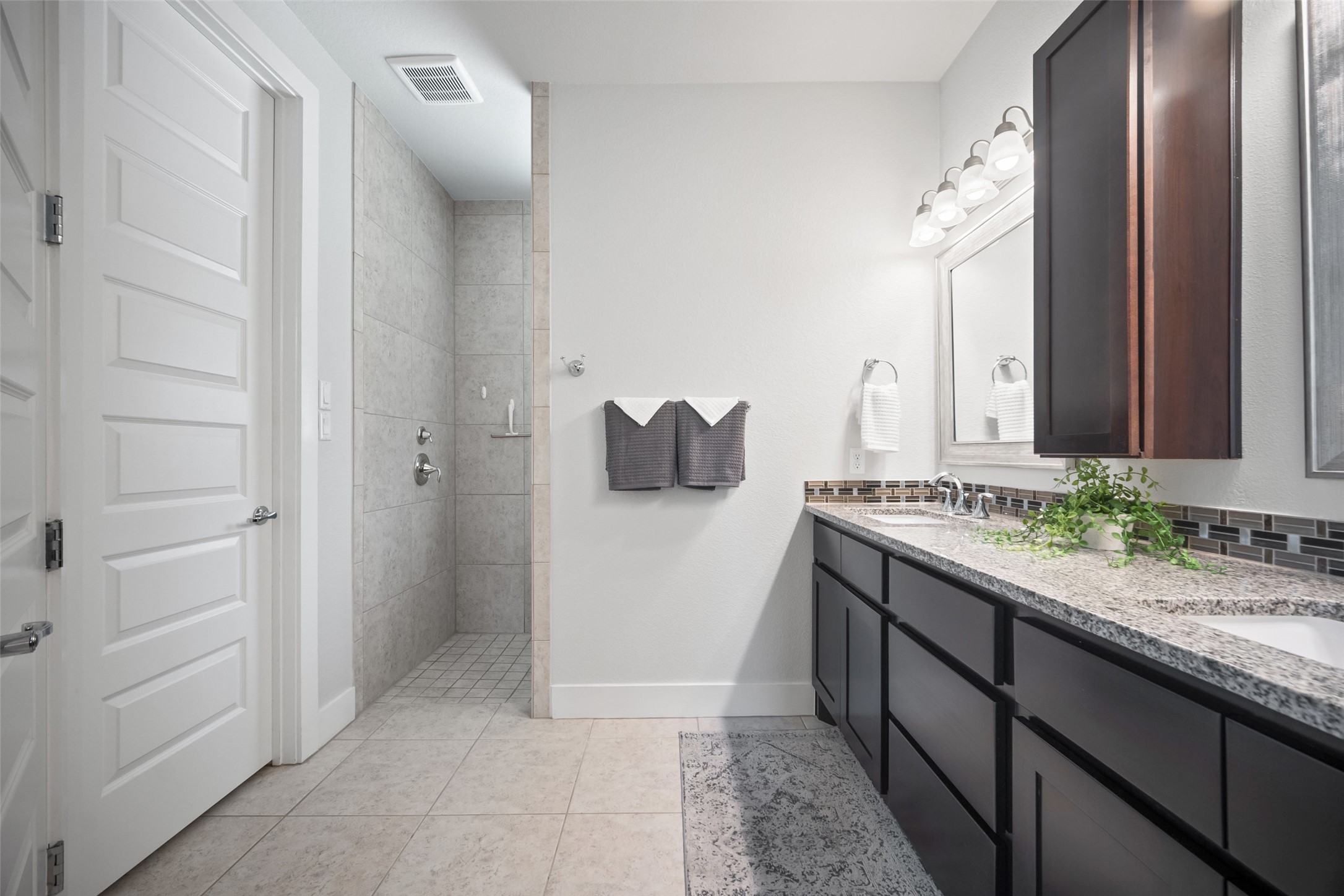 17644 West Reed Park Road Jonestown, TX 78645 - Photo 18 of 36 a bathroom with a granite countertop sink and a mirror