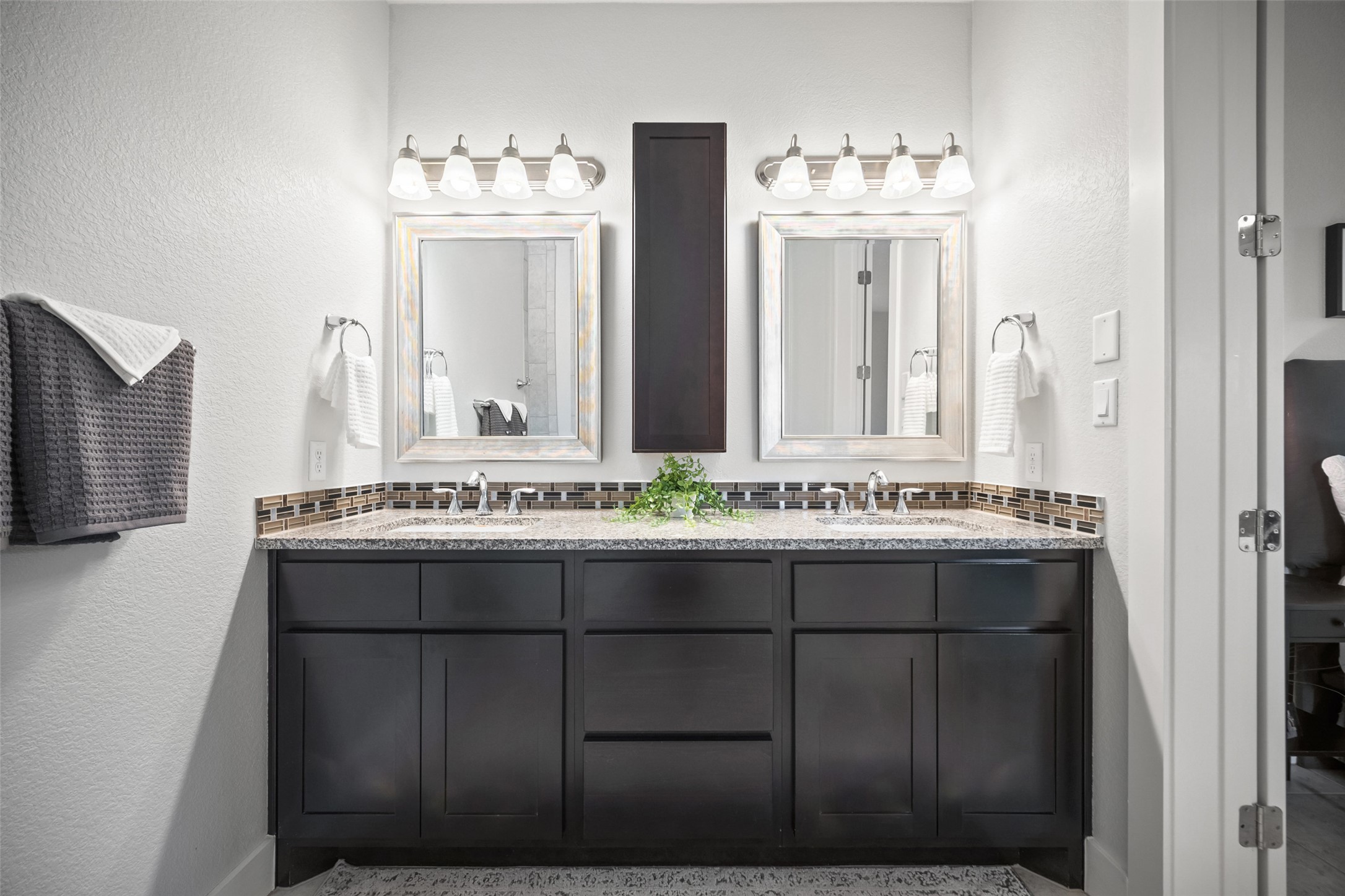 17644 West Reed Park Road Jonestown, TX 78645 - Photo 19 of 36 a bathroom with a double vanity sink and mirror