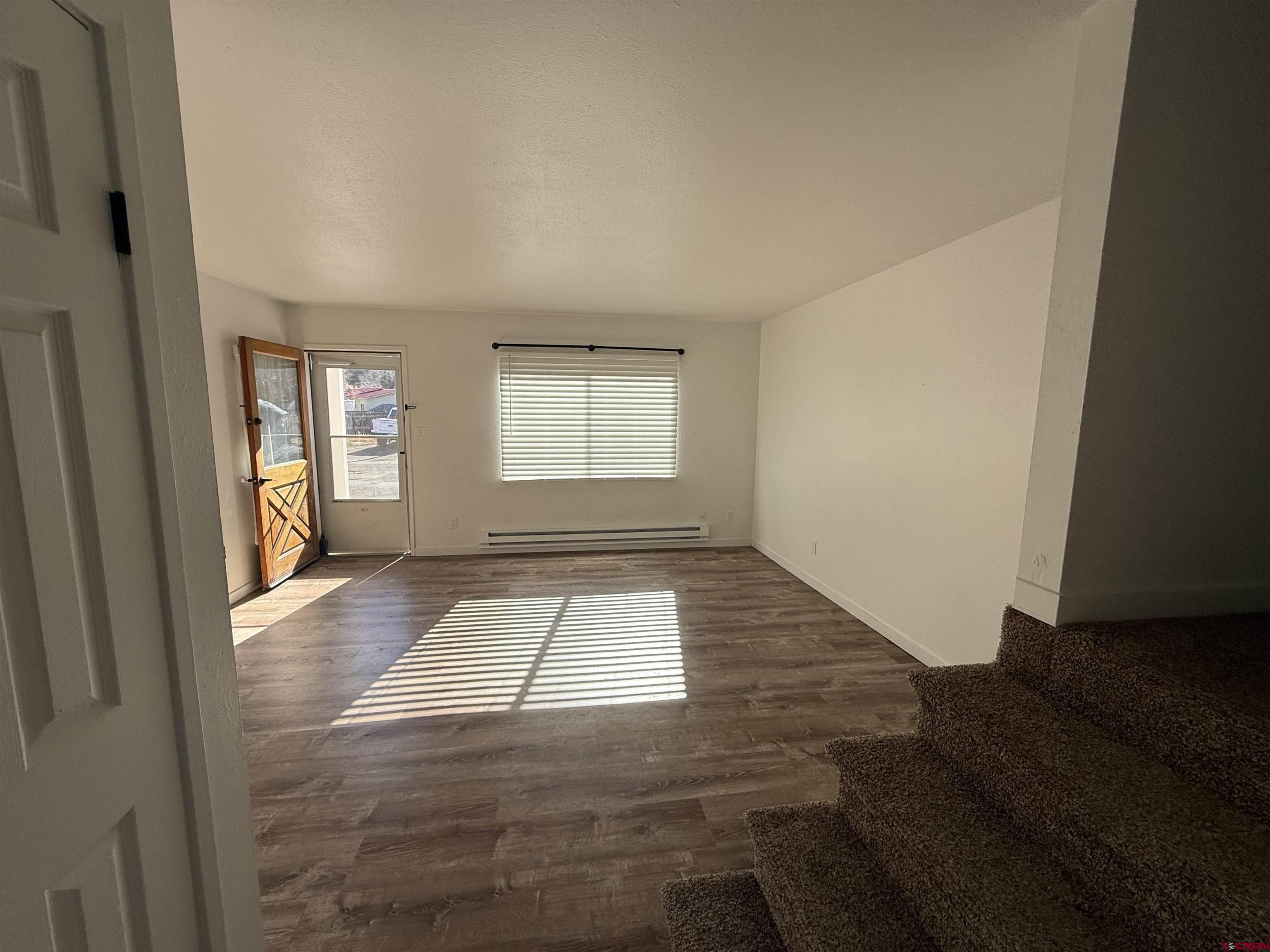 901 Florida Road, Unit 6 Durango, CO 81301 - Photo 15 of 21 an empty room with wooden floor and windows