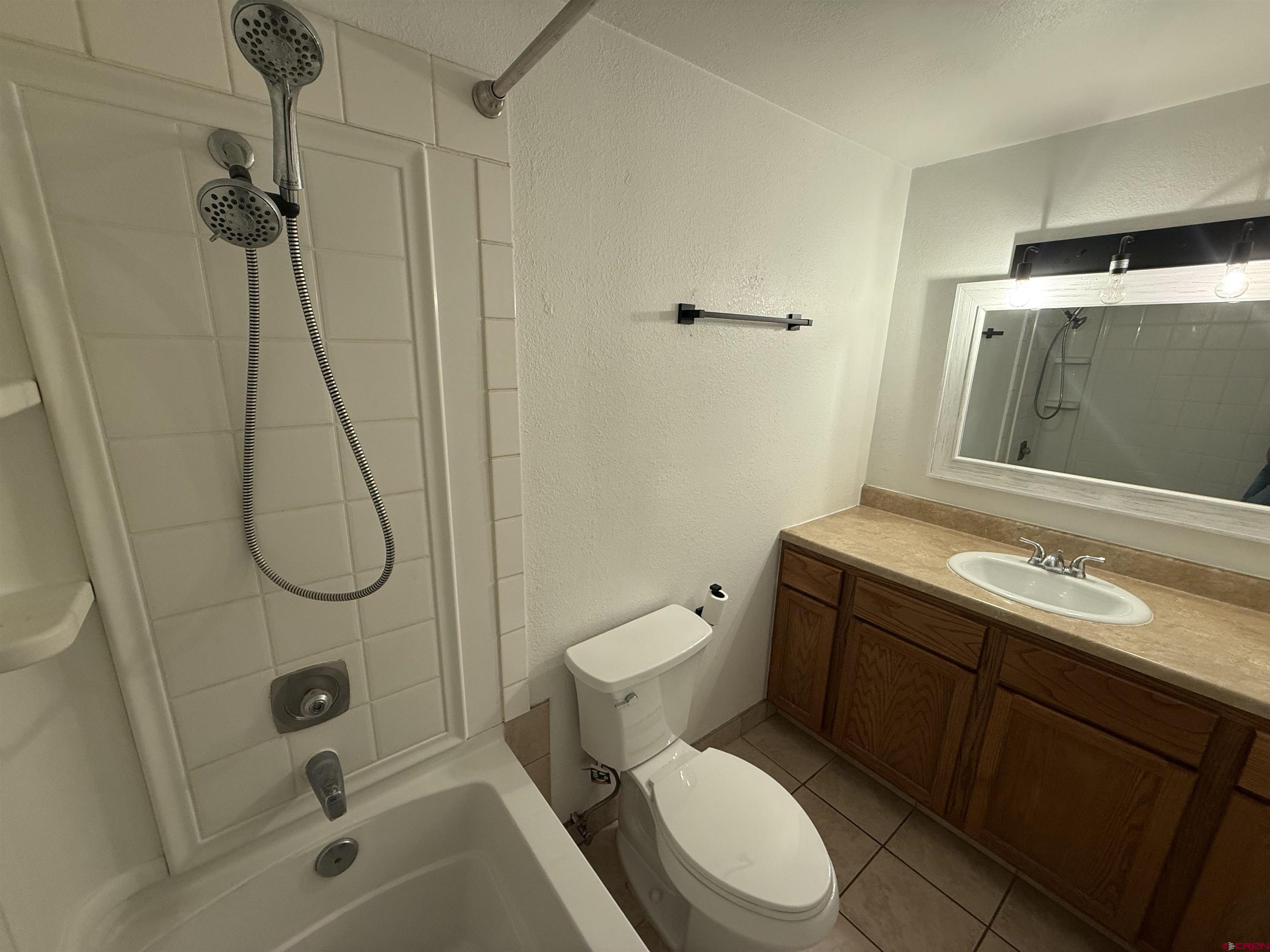 901 Florida Road, Unit 6 Durango, CO 81301 - Photo 6 of 21 a bathroom with a granite countertop toilet sink and shower
