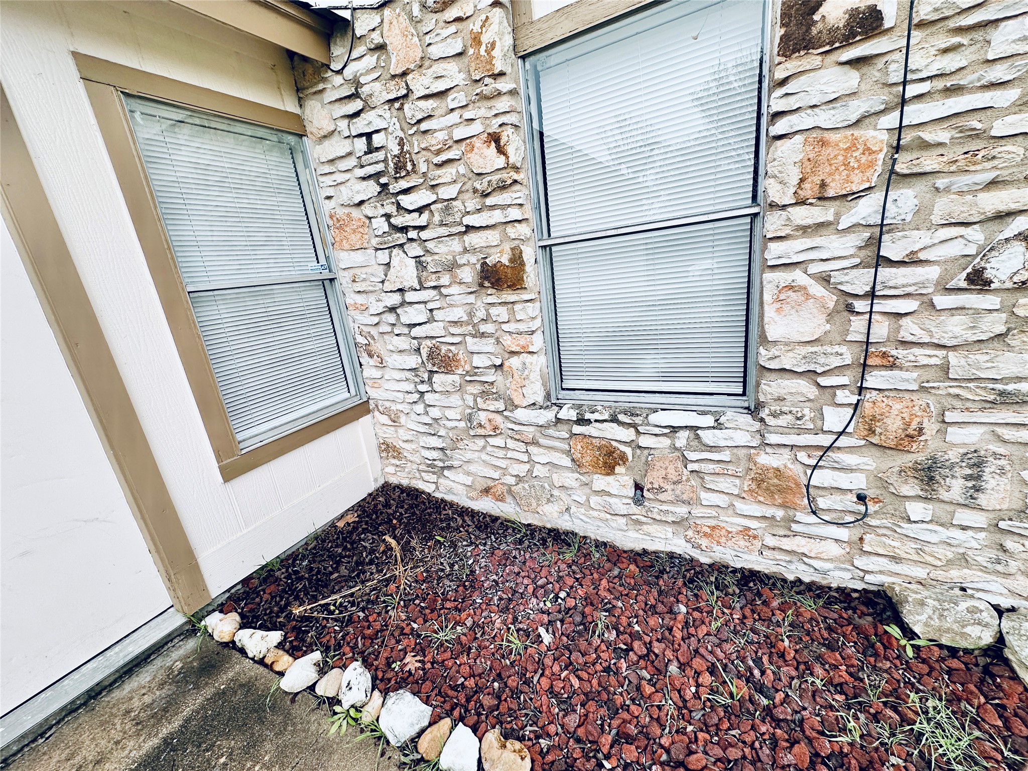 12505 Turtle Rock Road, Unit A Austin, TX 78729 - Photo 33 of 38 A striking exterior combines natural stone and traditional siding.