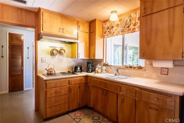 a kitchen with a sink stove and cabinets