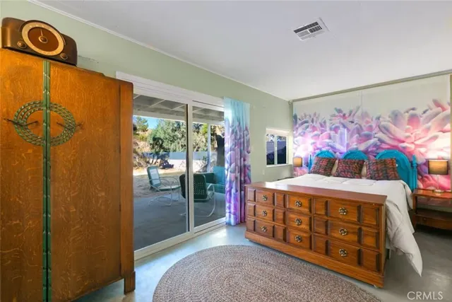 a bedroom with a bed and a dresser