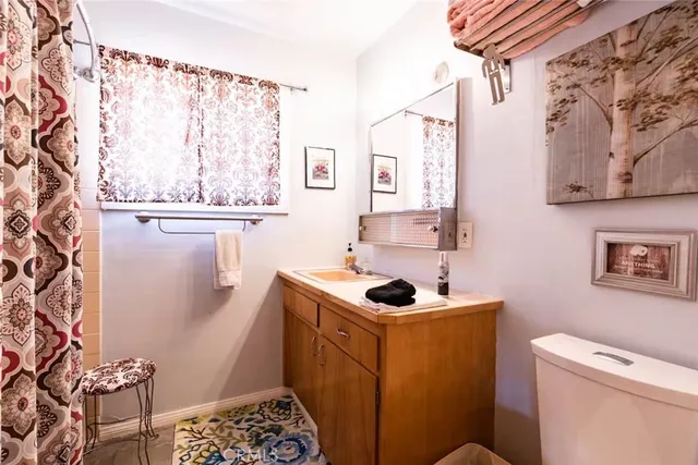 a bathroom with a sink toilet and window