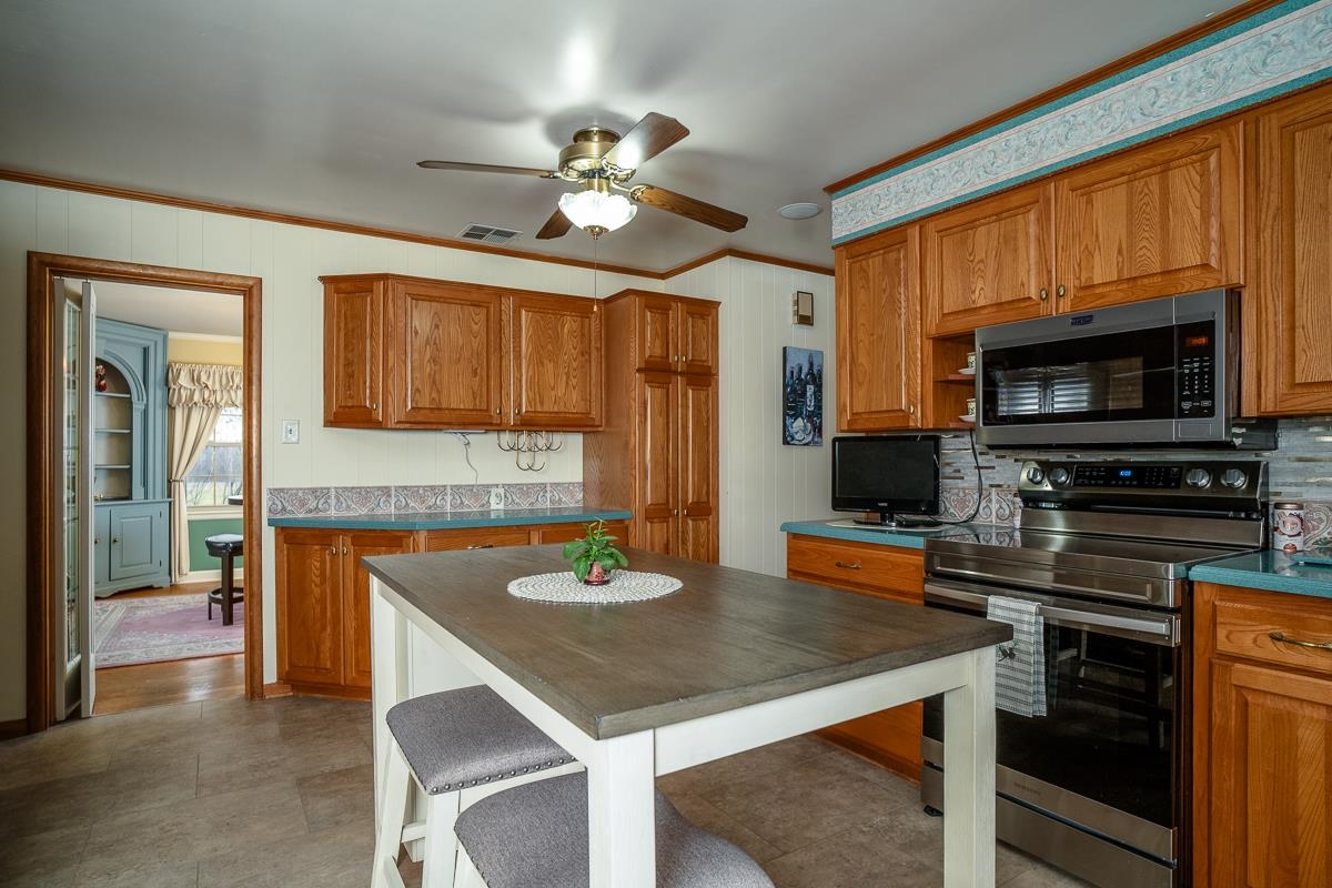 2769 Airport Road Bridgewater, VA 22812 - Photo 7 of 70 a kitchen with a table chairs microwave and cabinets