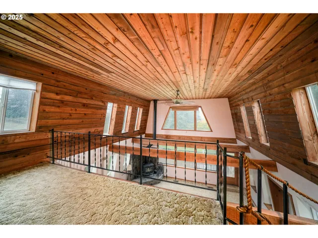 a view of staircase with lots of frames on wall