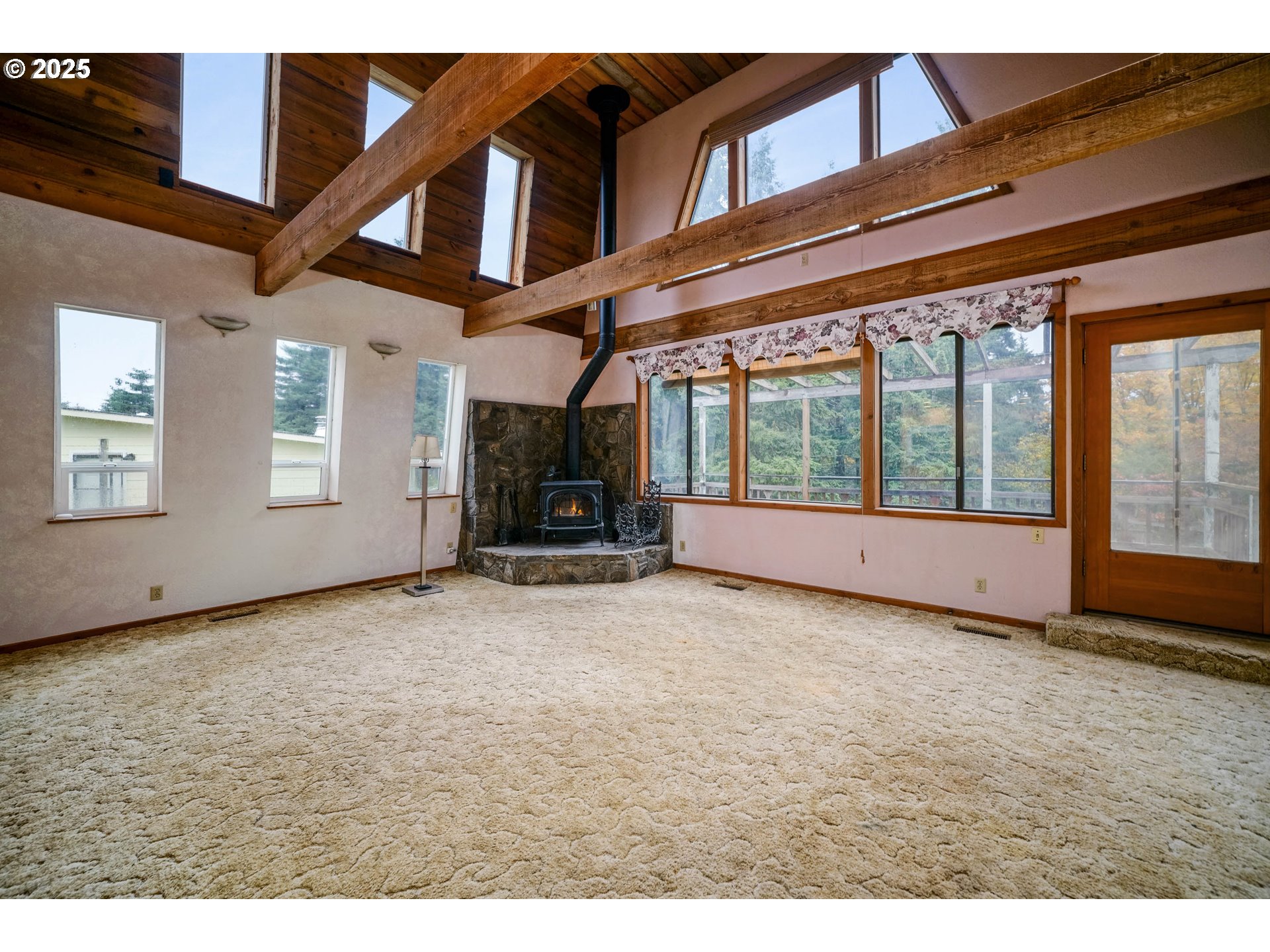 20125 McKillop Road Scotts Mills, OR 97375 - Photo 5 of 47 a view of an empty room with a fireplace and windows
