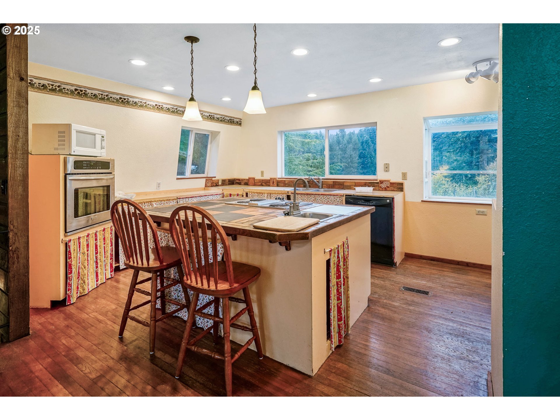 20125 McKillop Road Scotts Mills, OR 97375 - Photo 9 of 47 a kitchen that has a lot of cabinets a sink and a wooden floor