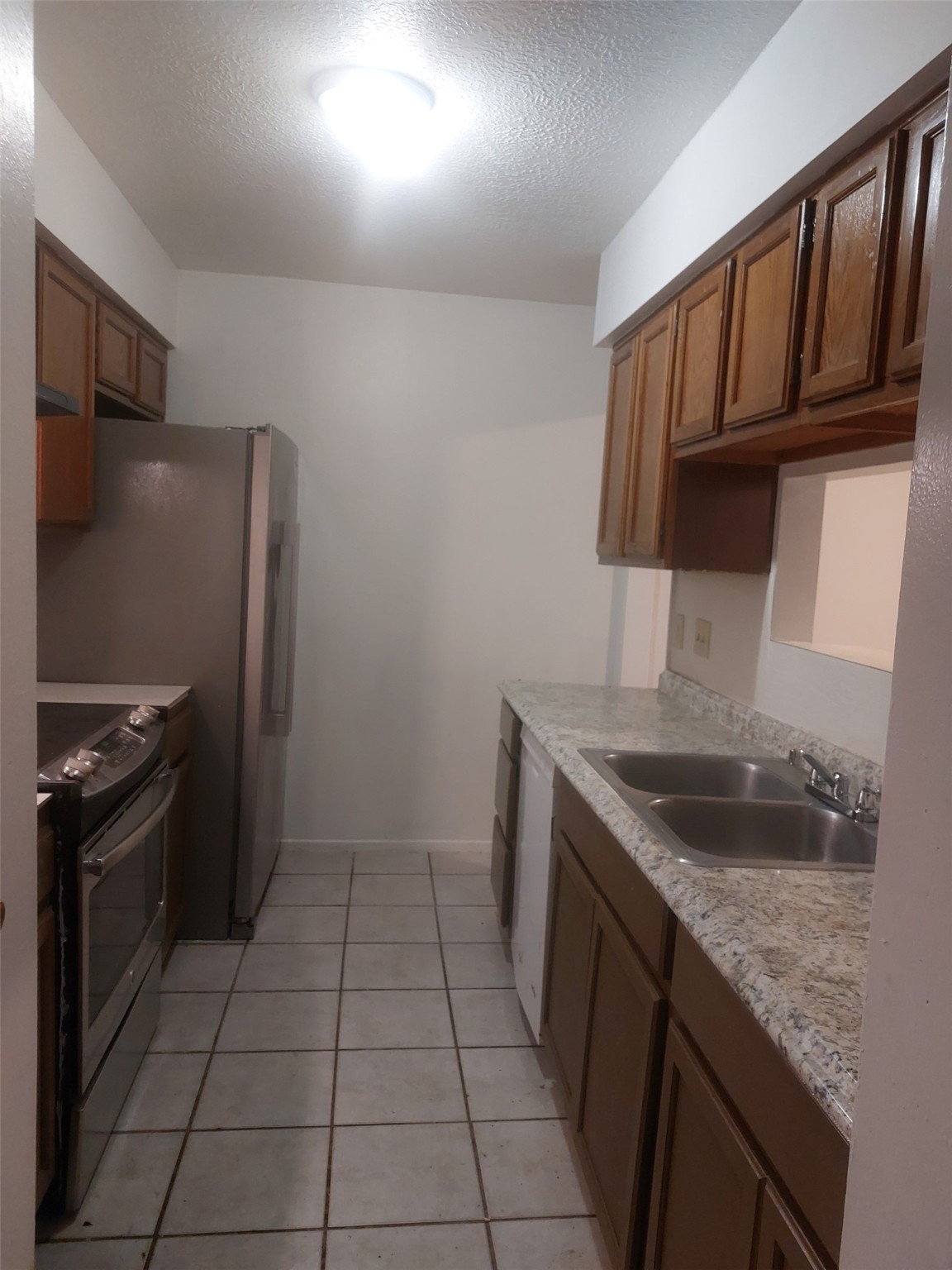 8151 Misty Ridge Lane Houston, TX 77071 - Photo 9 of 15 a kitchen with granite countertop a sink stove and refrigerator