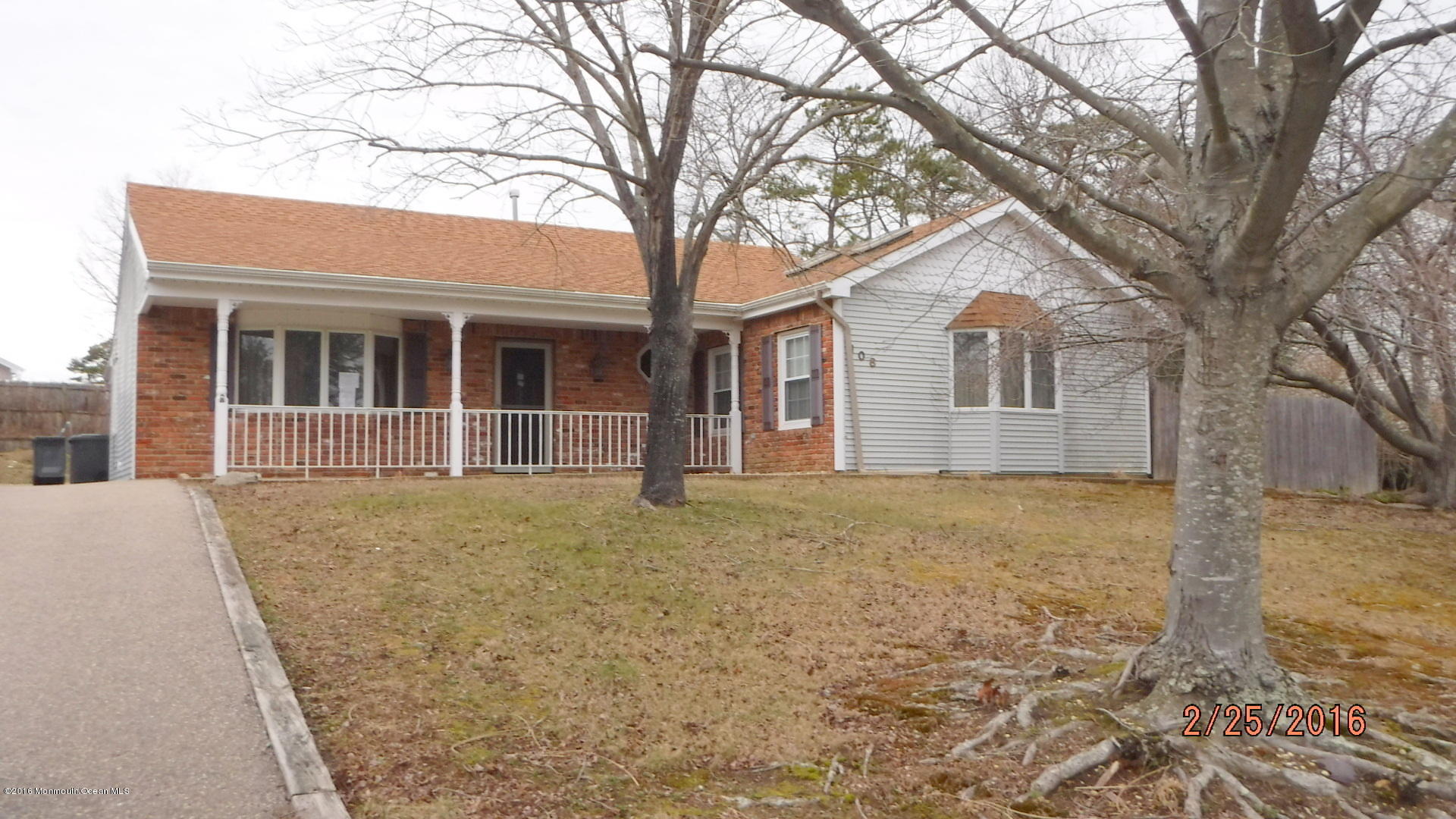 108 Toggle Road Manahawkin, NJ 08050 - Photo 1 of 11 front view of a house with a trees